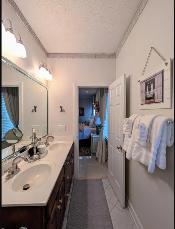 Bright full bathroom with double vanity and fresh towels