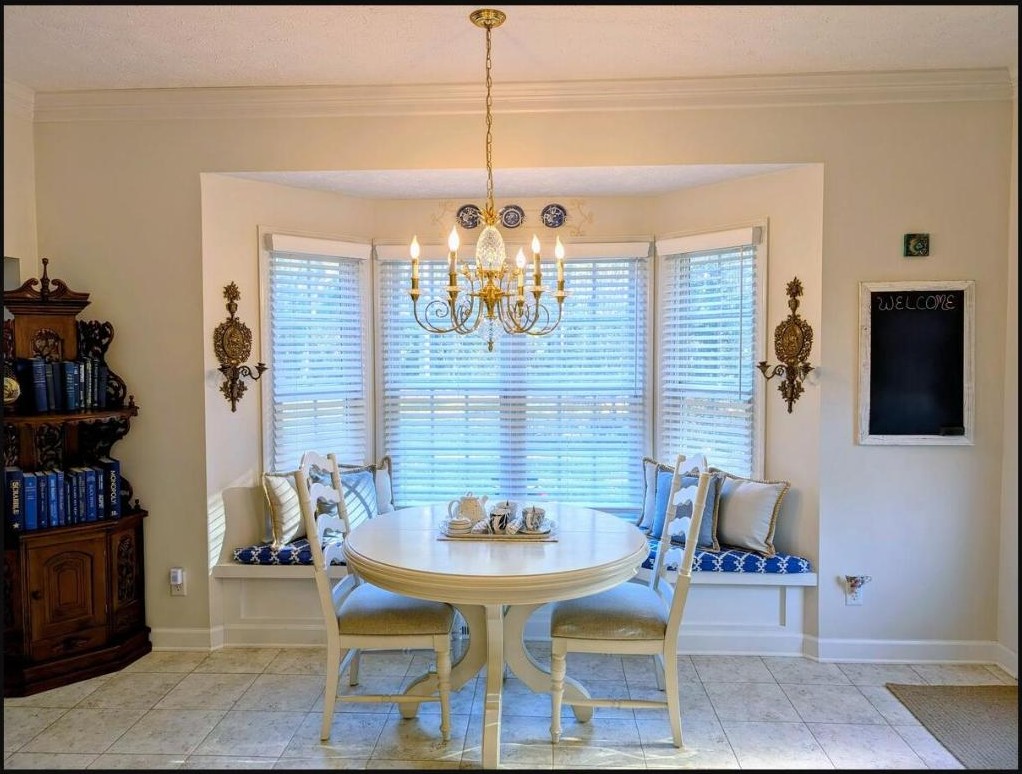 Sunny bay-window dining nook with a round table set for two