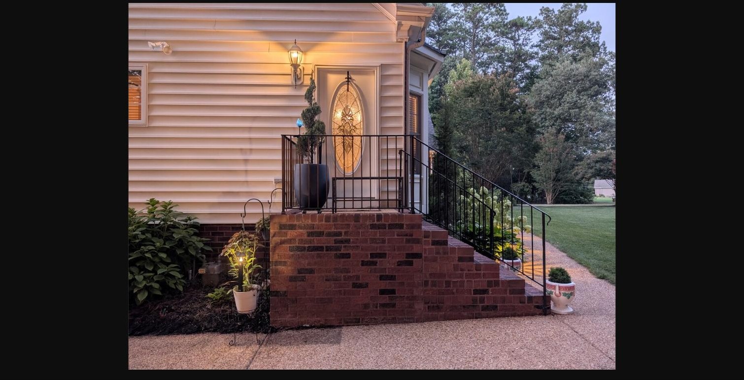Front entry steps and glowing door at dusk