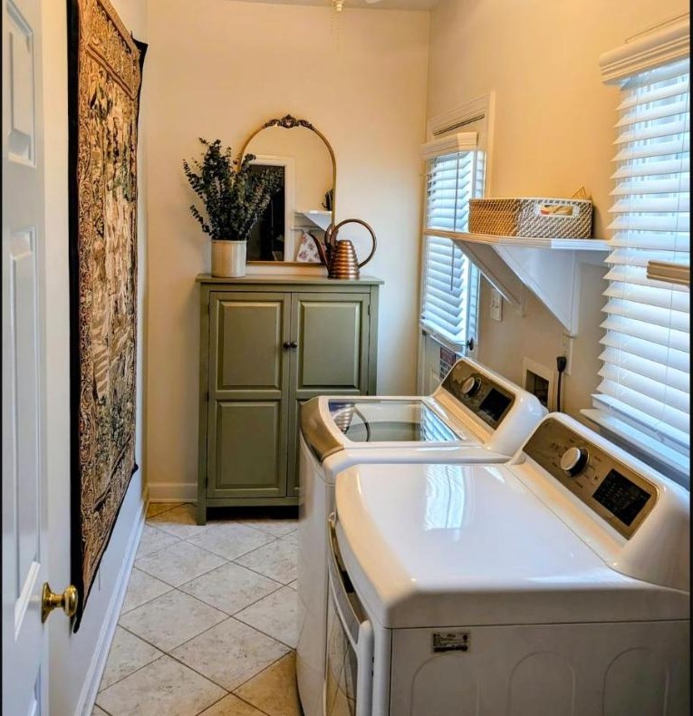 In-suite laundry area with washer, dryer, and vintage green cabinet