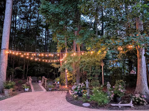 String-lit garden path near the Granny Chic Suite at dusk